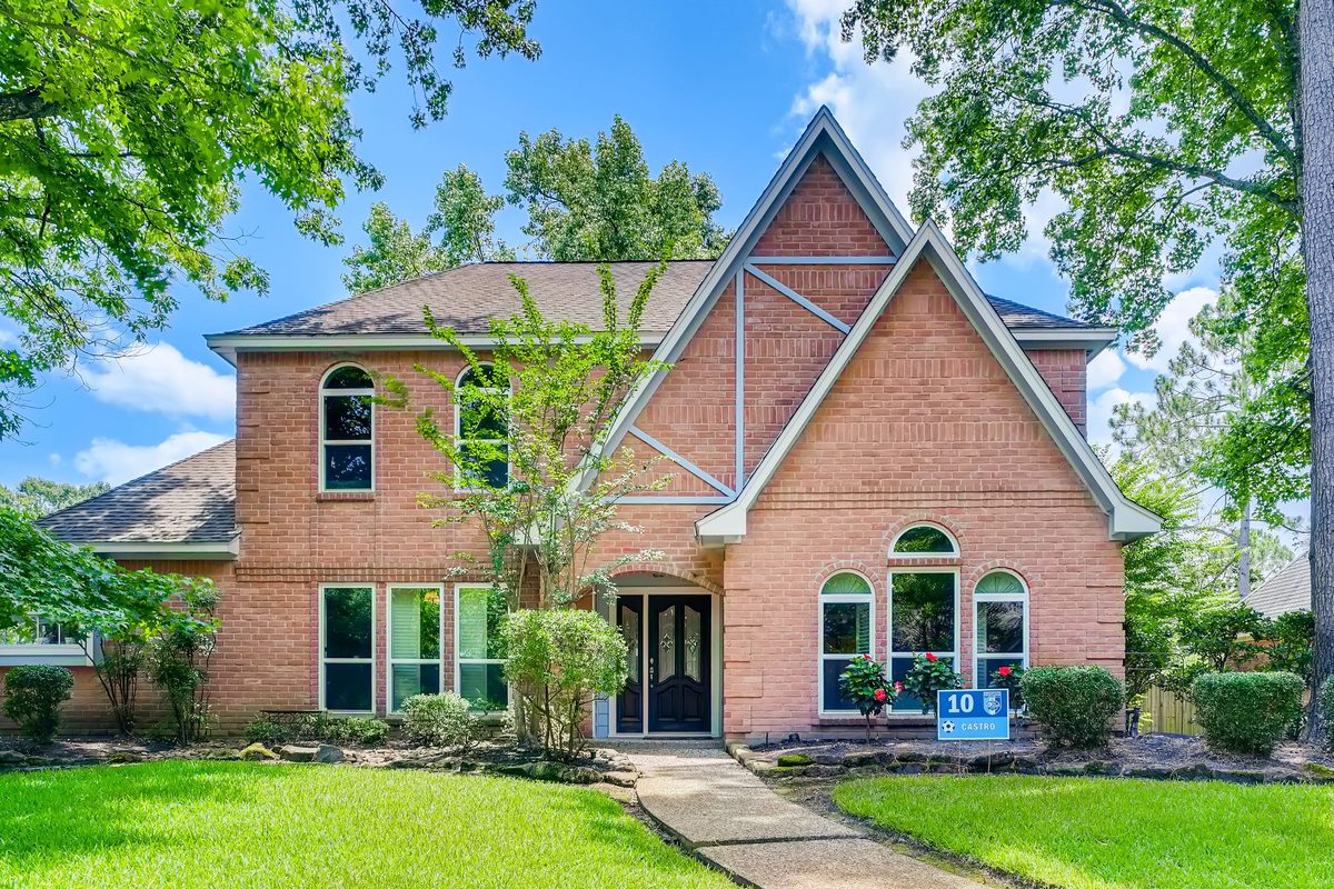 Brick home with a green front lawn